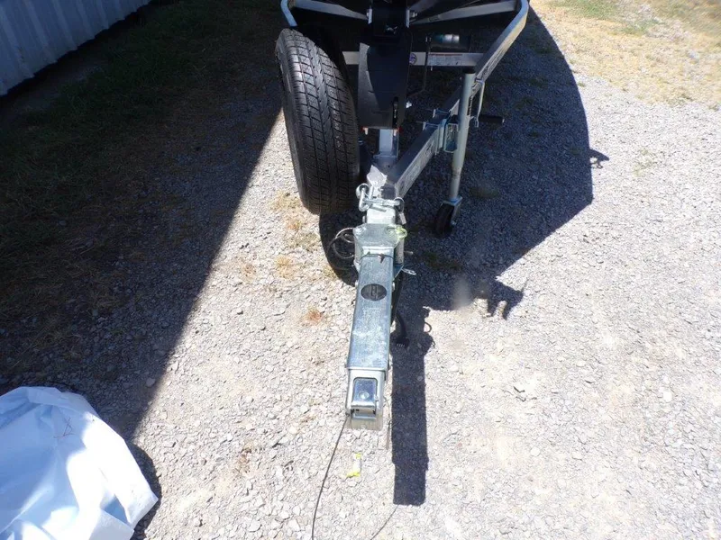 Slide: The Image of Trailer hitch of 2026 Xpress H20 Bass boat on gravel surface. - 26