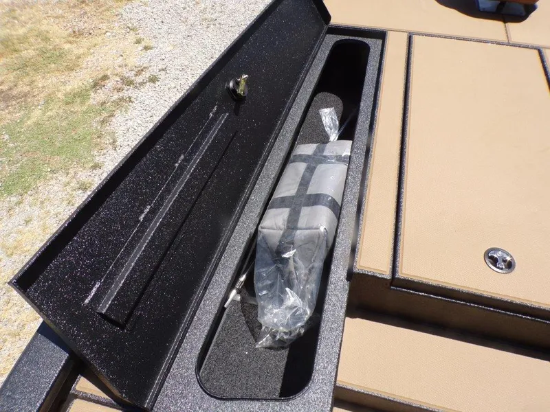Slide: The Image of Storage compartment in 2026 Xpress H20 Bass boat, featuring secure latch and organized interior. - 6