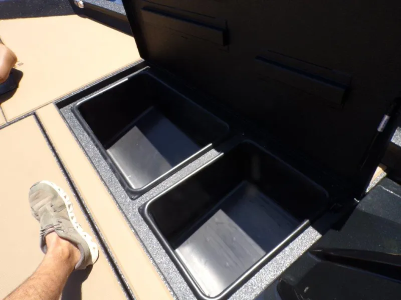 Slide: The Image of Open storage compartments on a 2026 Xpress H20 Bass boat deck. - 8