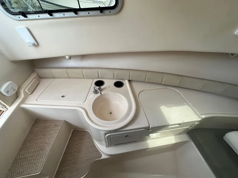 Slide: The Image of 2014 Grady-White 232 Gulfstream boat interior with sink and storage area. - 12