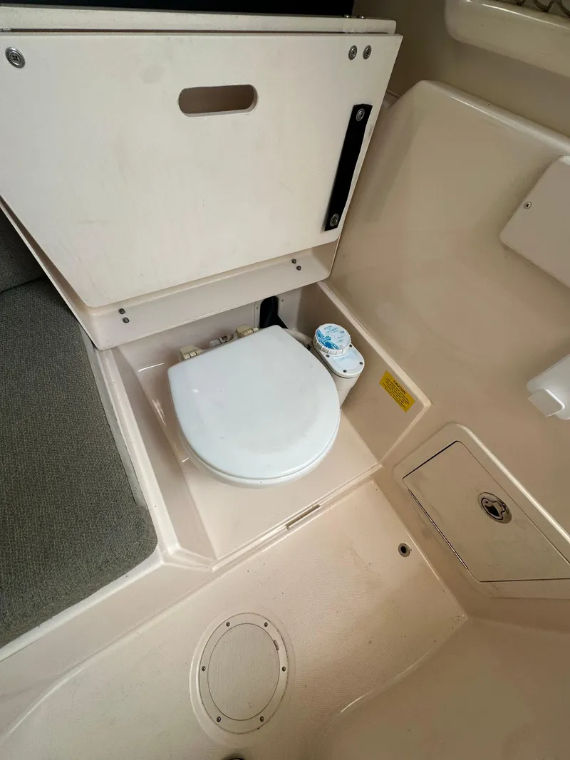 Slide: The Image of 2014 Grady-White 232 Gulfstream boat interior with compact marine toilet. - 13
