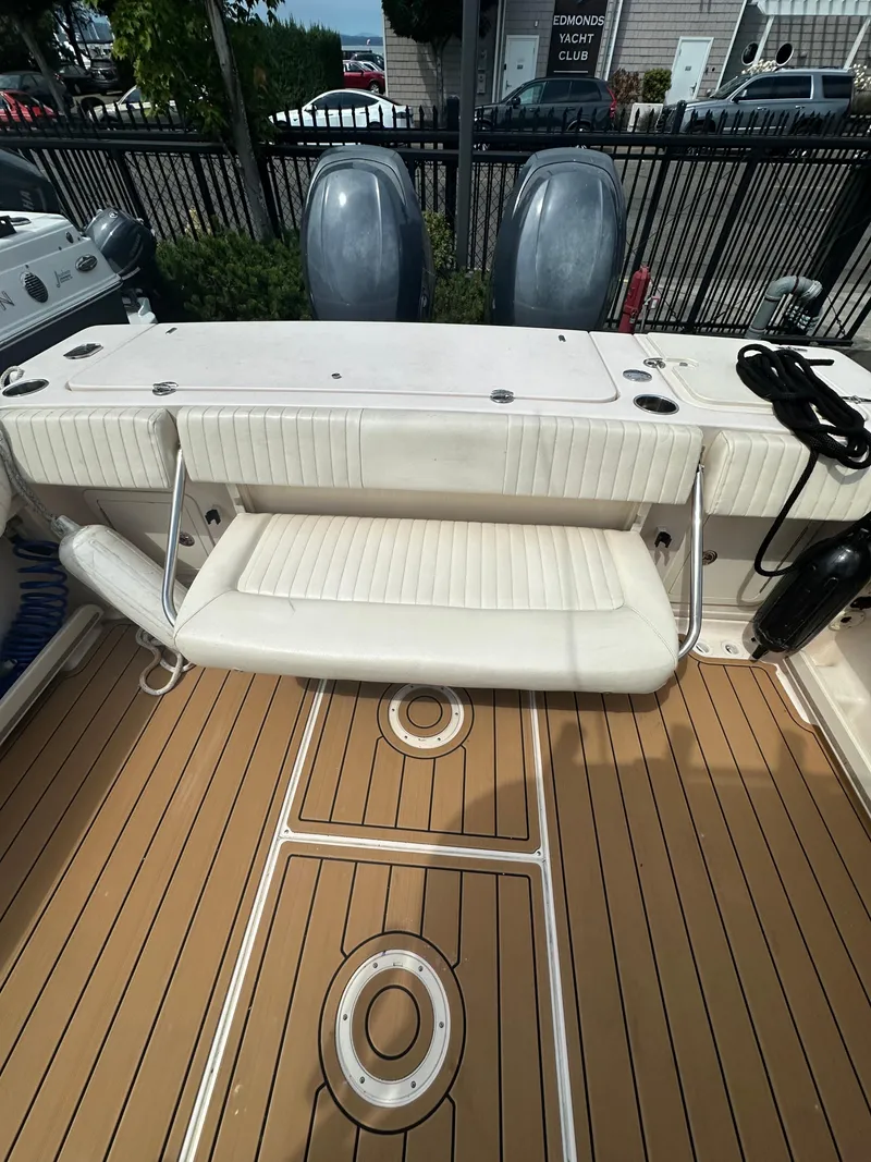 Slide: The Image of 2014 Grady-White 232 Gulfstream boat with foldable seat and teak-style deck. - 15