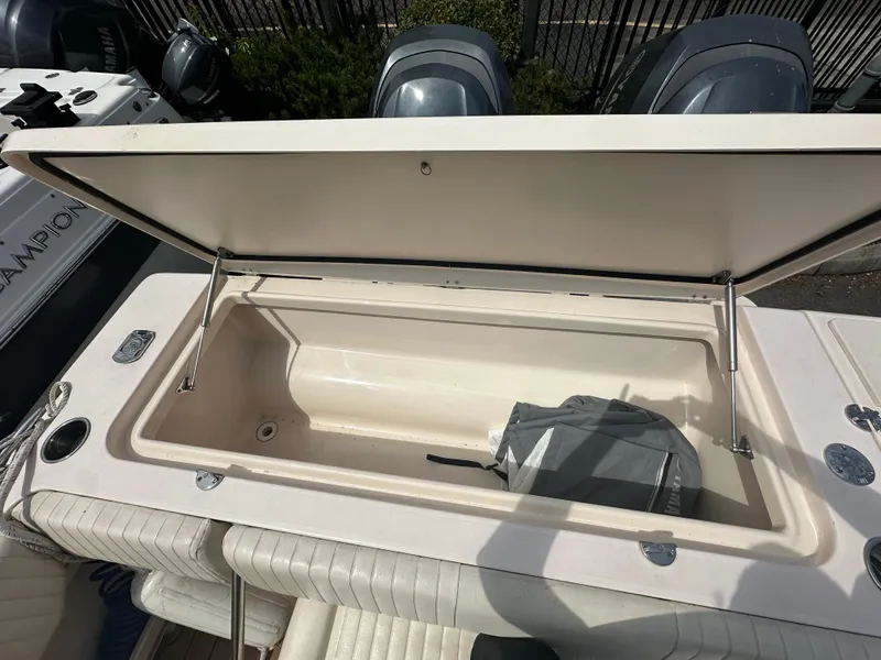 Slide: The Image of Open storage compartment on 2014 Grady-White 232 Gulfstream boat, showing interior space. - 16