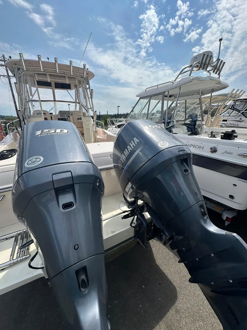Slide: The Image of 2014 Grady-White 232 Gulfstream boat with Yamaha outboard motors, under a partly cloudy sky. - 17