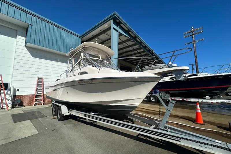 Slide: The Image of 2014 Grady-White Gulfstream 232 boat on trailer outside a storage facility. - 2