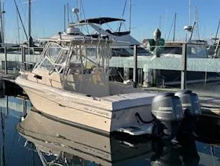 Slide: The Image of 2014 Grady-White 232 Gulfstream boat docked in marina with twin outboard engines. - 3