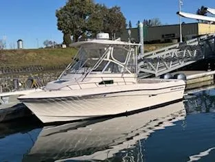 Slide: The Image of 2014 Grady-White 232 Gulfstream boat docked at marina on a sunny day. - 5