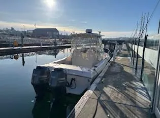 Slide: The Image of 2014 Grady-White 232 Gulfstream boat docked in a marina under clear skies. - 7