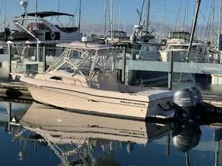 Slide: The Image of 2014 Grady-White 232 Gulfstream boat docked in a marina with calm waters. - 8