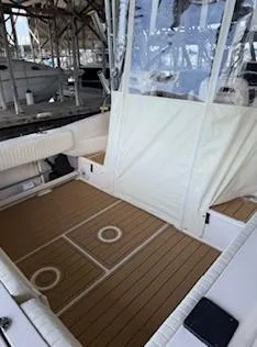 Slide: The Image of 2014 Grady-White 232 Gulfstream boat interior with teak flooring and white seating. - 9