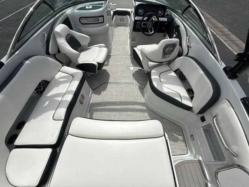 Slide: The Image of 2022 Crownline Eclipse E235 SURF boat interior with luxurious white seating and modern dashboard. - 10