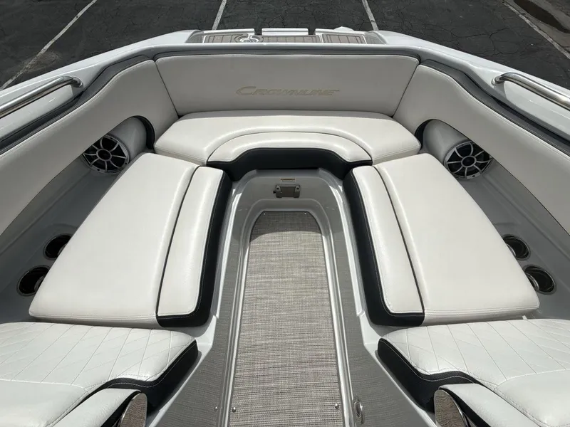 Slide: The Image of 2022 Crownline Eclipse E235 SURF boat interior with white cushioned seating. - 11