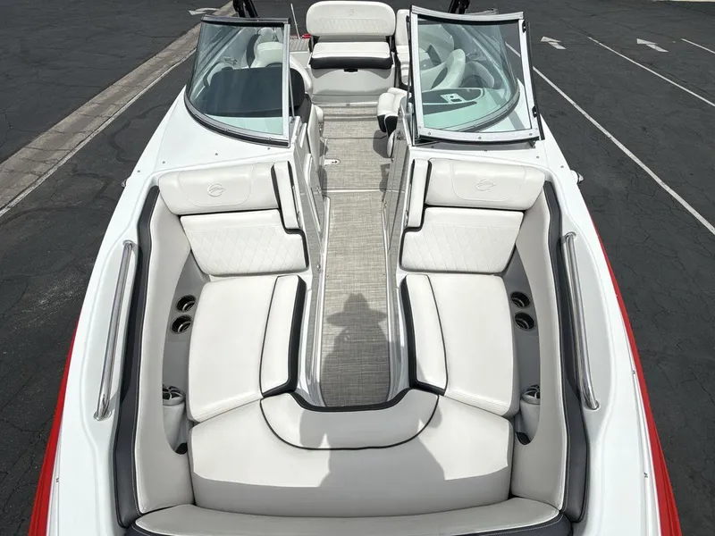Slide: The Image of 2022 Crownline Eclipse E235 SURF boat interior with white seating and open windshield. - 12