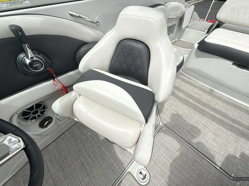 Slide: The Image of 2022 Crownline Eclipse E235 SURF boat interior with luxurious seating and modern controls. - 13