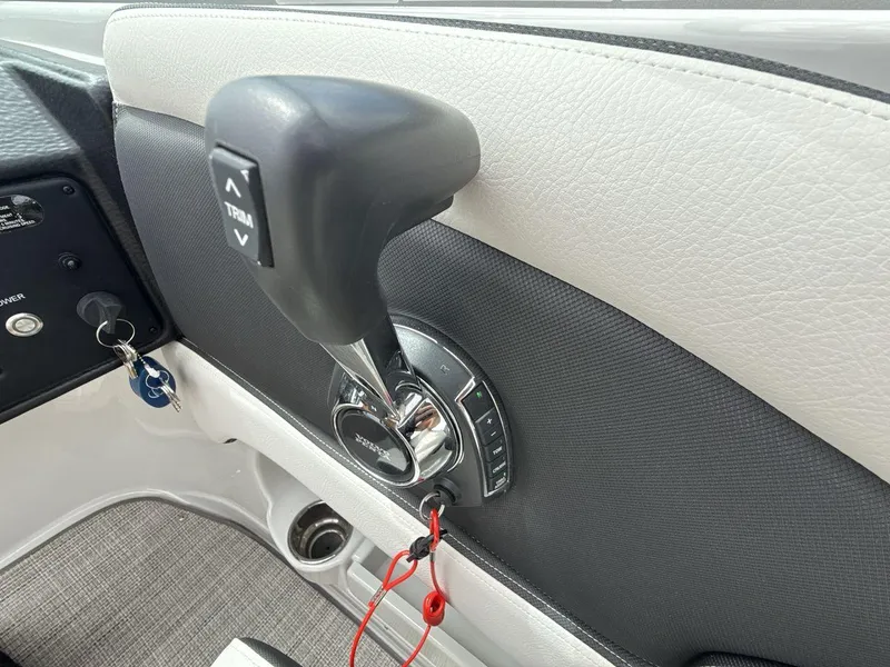 Slide: The Image of 2022 Crownline Eclipse E235 SURF throttle control with trim buttons and ignition keys. - 16