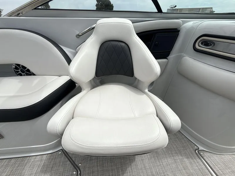 Slide: The Image of 2022 Crownline Eclipse E235 SURF boat interior with white cushioned seating. - 17