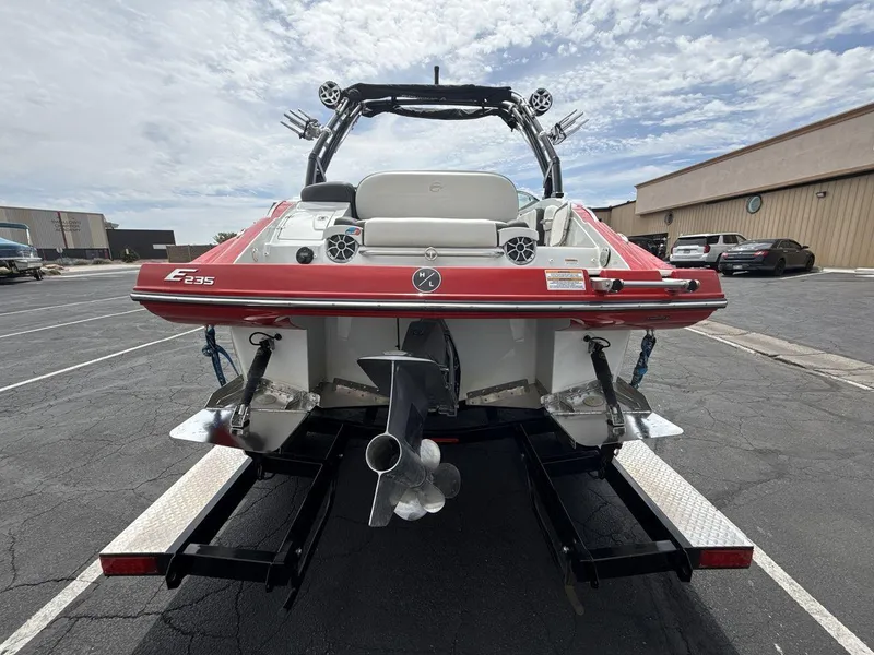 Slide: The Image of 2022 Crownline Eclipse E235 SURF boat on trailer, rear view in parking lot. - 4