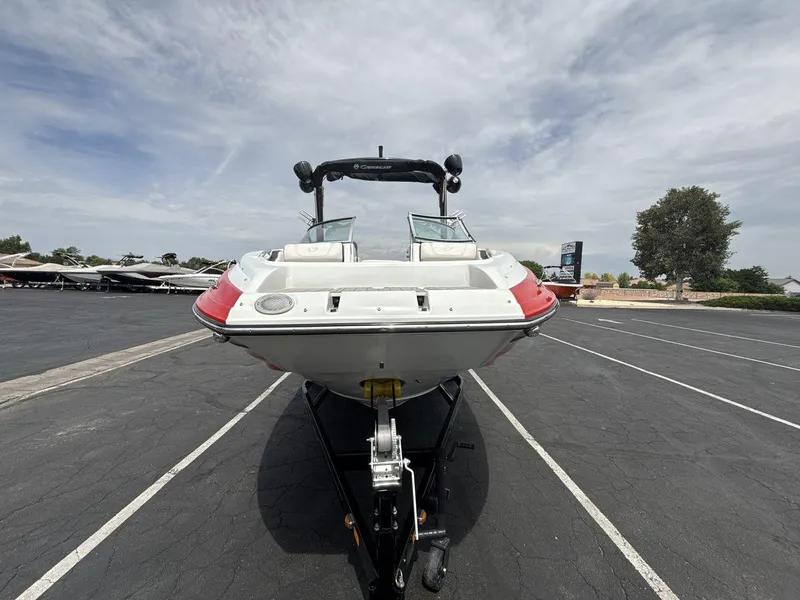 Slide: The Image of 2022 Crownline Eclipse E235 SURF boat on trailer in parking lot. - 8