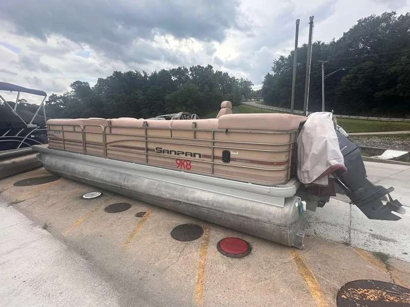 Slide: The Image of 2008 Godfrey Sanpan 2500 RE pontoon boat parked on concrete under cloudy sky. - 4