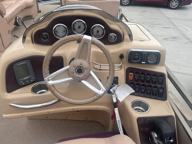 Slide: The Image of 2008 Godfrey Sanpan 2500 RE boat dashboard with steering wheel and control panel. - 7