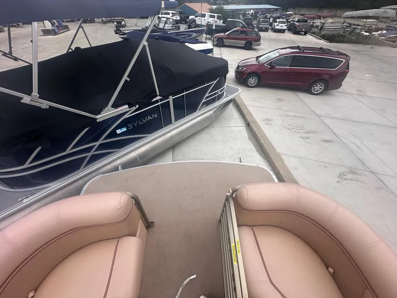 Slide: The Image of 2008 Godfrey Sanpan 2500 RE pontoon boat in a parking lot with other vehicles. - 8