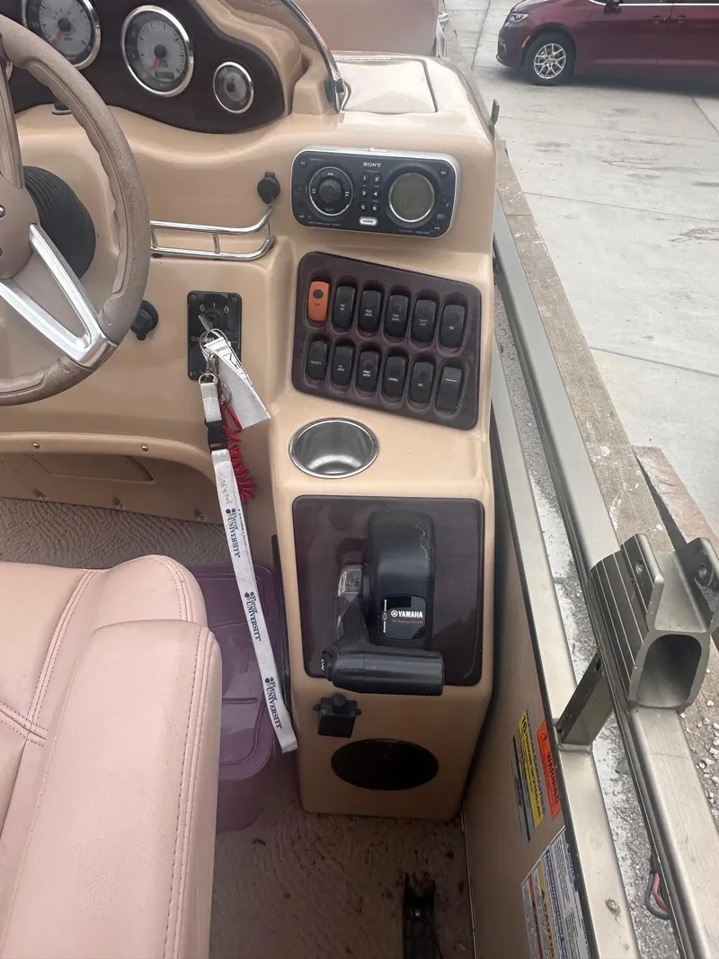 Slide: The Image of 2008 Godfrey Sanpan 2500 RE boat dashboard with controls and Yamaha throttle. - 9