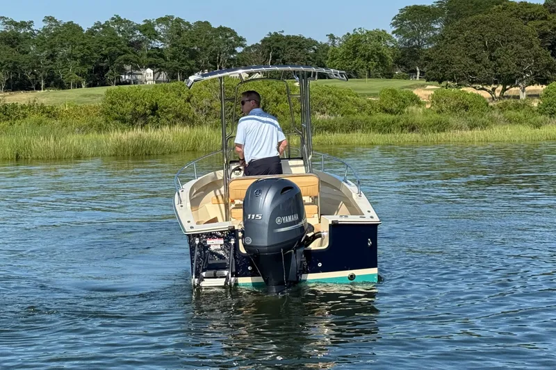 Slide: The Image of A 2026 Rossiter 17 boat with Yamaha engine on a calm lake. - 11