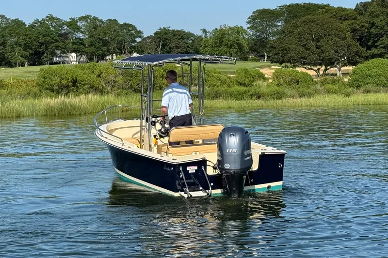 Slide: The Image of 2026 Rossiter 17 boat cruising on a calm lake with lush greenery in the background. - 12
