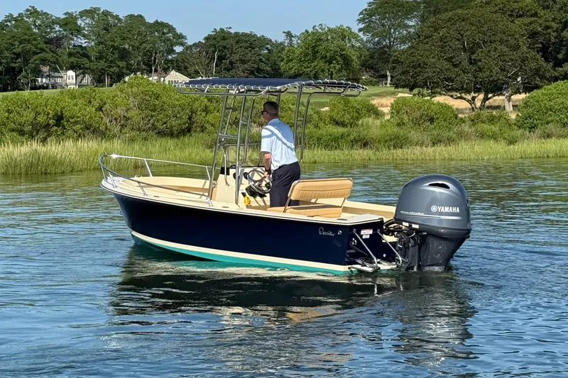 Slide: The Image of 2026 Rossiter 17 boat with Yamaha engine on calm water, surrounded by lush greenery. - 13