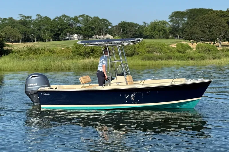 Slide: The Image of 2026 Rossiter 17 boat on calm water with Yamaha engine, lush greenery in background. - 8