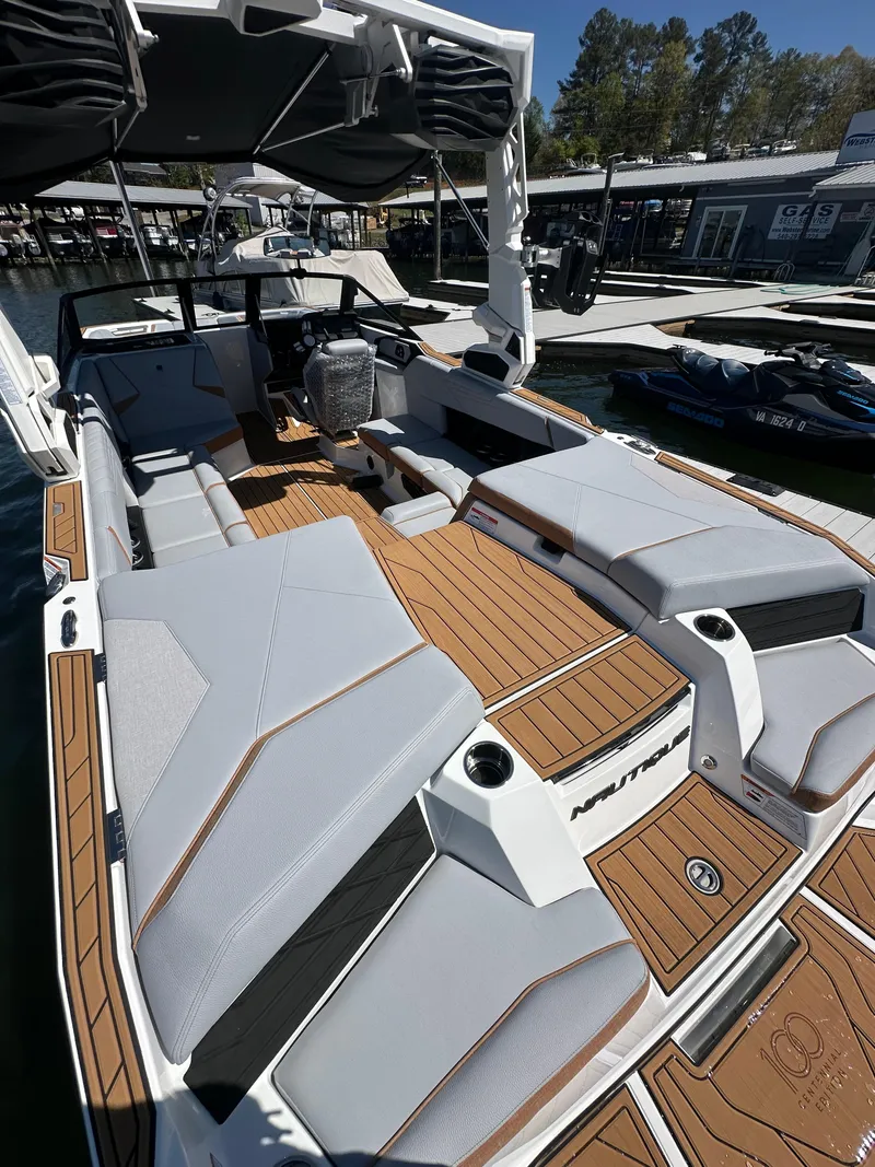 Slide: The Image of 2025 Nautique Super Air Nautique S23 boat interior with sleek seating and modern design. - 11