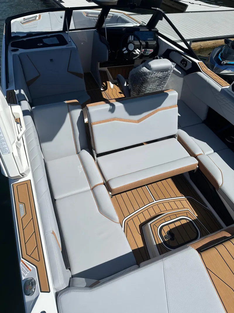 Slide: The Image of 2025 Nautique Super Air Nautique S23 interior with luxurious seating and modern design. - 13