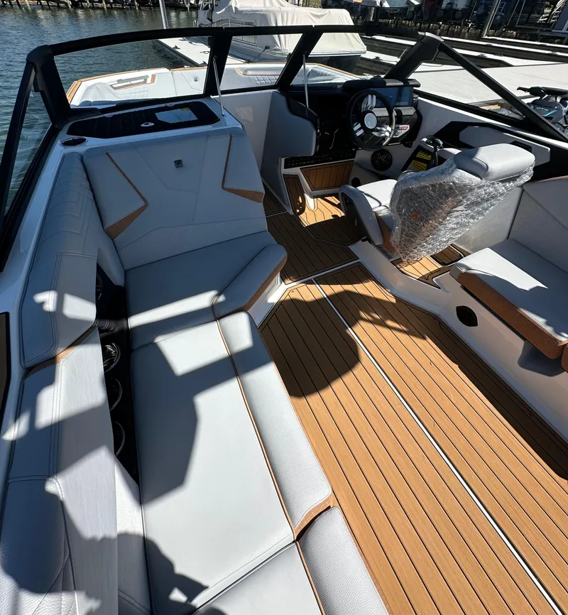 Slide: The Image of 2025 Nautique Super Air Nautique S23 interior with sleek seating and modern dashboard design. - 14