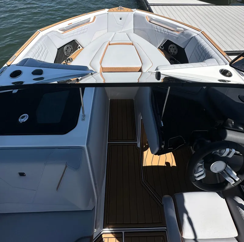 Slide: The Image of 2025 Nautique Super Air Nautique S23 boat interior with luxurious seating and modern design. - 19
