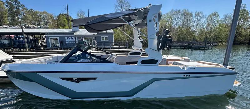 Slide: The Image of 2025 Nautique Super Air Nautique S23 boat docked on a sunny day. - 3