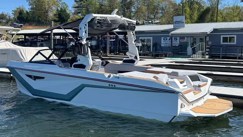 Slide: The Image of 2025 Nautique Super Air Nautique S23 boat docked at marina. - 4