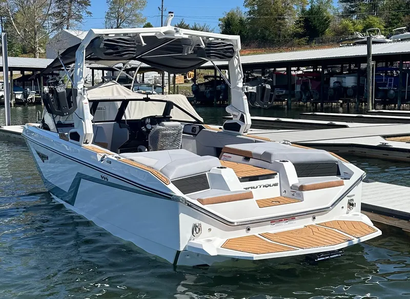 Slide: The Image of 2025 Nautique Super Air Nautique S23 boat docked on a sunny day. - 7