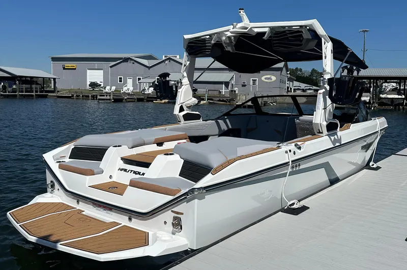 Slide: The Image of 2025 Nautique Super Air Nautique S23 boat docked, showcasing sleek design and modern features. - 8