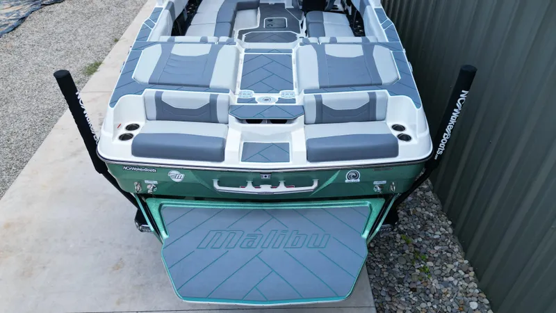 Slide: The Image of 2025 Malibu Wakesetter 23 LSV boat, rear view, featuring spacious seating and sleek design. - 17