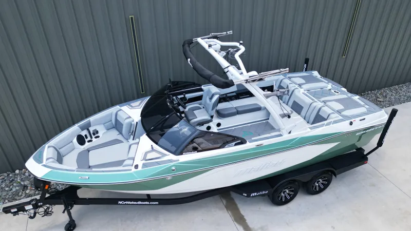 Slide: The Image of 2025 Malibu Wakesetter 23 LSV boat on trailer, sleek design, mint and white color scheme. - 5