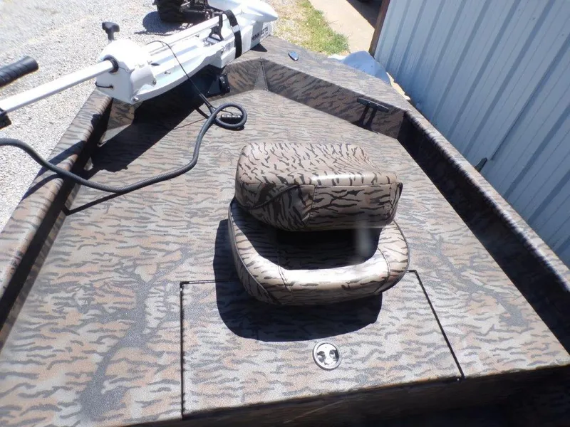 Slide: The Image of 2026 Xpress XP18CC boat with camouflage seating and trolling motor. - 10