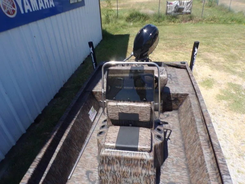 Slide: The Image of 2026 Xpress XP18CC boat with camouflage design, parked near a Yamaha sign. - 11