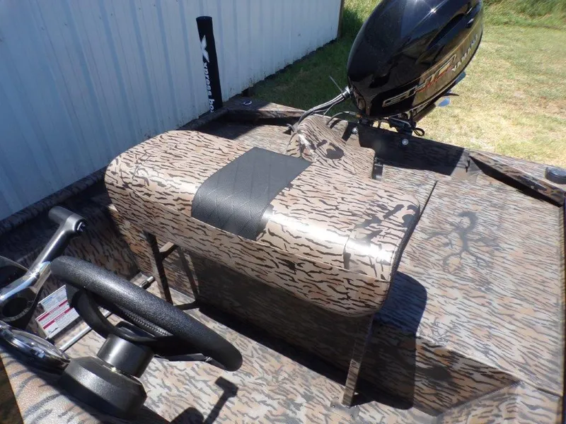 Slide: The Image of 2026 Xpress XP18CC boat interior with camouflage design and steering wheel. - 12