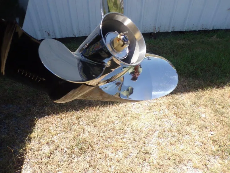 Slide: The Image of Shiny propeller of 2026 Xpress XP18CC boat on grass background. - 13