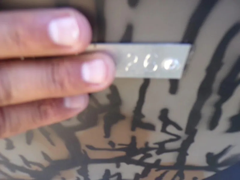 Slide: The Image of Hand holding a metal plate with "2026" on Xpress XP18CC boat. - 14