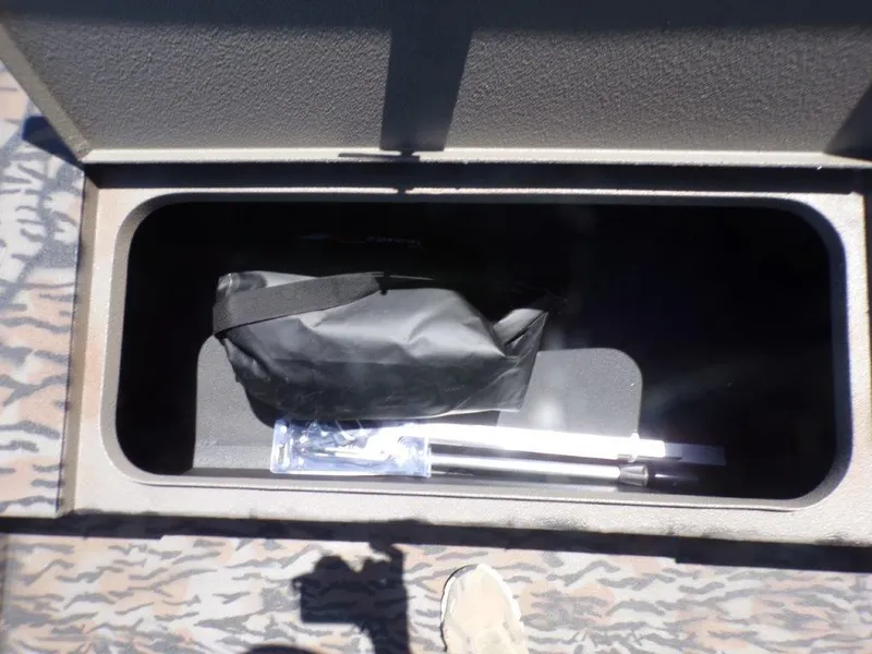 Slide: The Image of Storage compartment in 2026 Xpress XP18CC boat with bag and equipment. - 5
