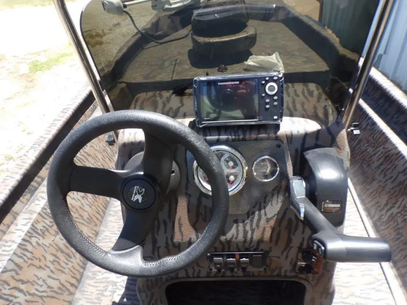 Slide: The Image of 2026 Xpress XP18CC boat dashboard with steering wheel, gauges, and navigation system. - 6