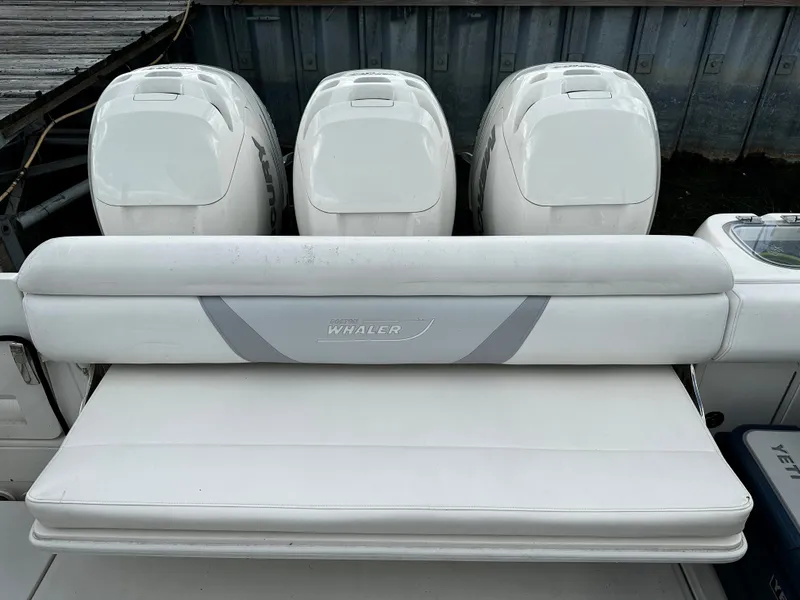 Slide: The Image of 2014 Boston Whaler 370 Outrage with blue LED lights docked at night. - 13