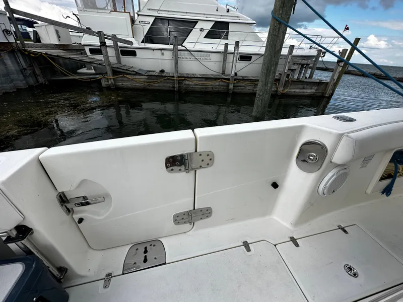 Slide: The Image of 2014 Boston Whaler 370 Outrage boat stern with triple outboard engines. - 15