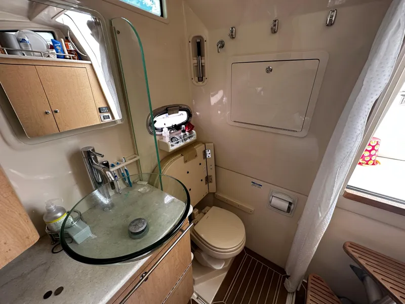 Slide: The Image of Interior view of 2014 Boston Whaler 370 Outrage boat, featuring white seating and storage compartments. - 20